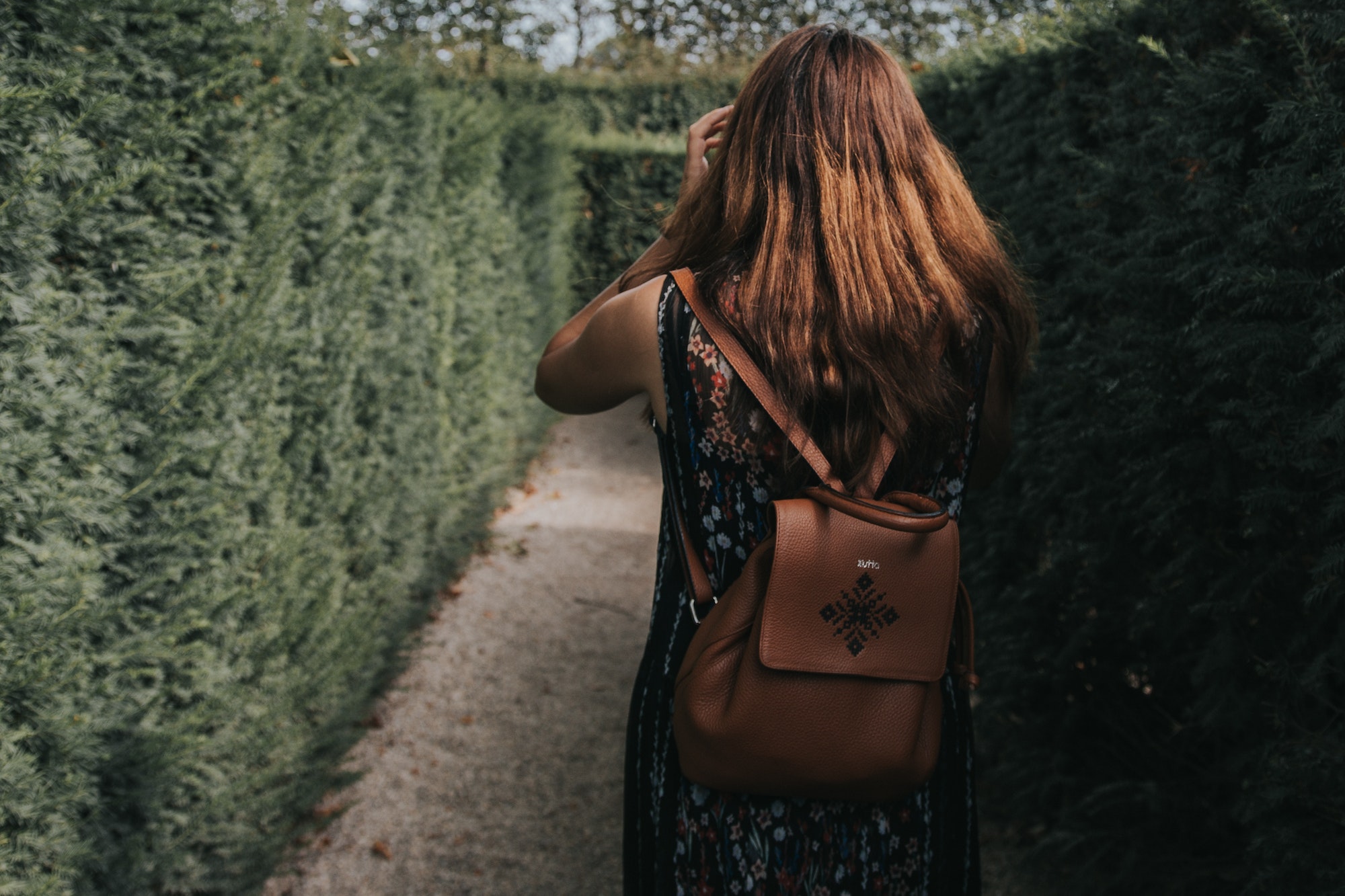 Girl getting lost in a hedge maze