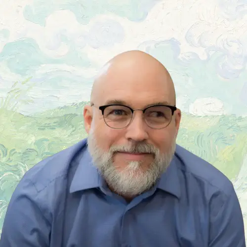 A bearded man with glasses and a blue shirt smiles gently, sitting in front of a painted background resembling a Van Gogh landscape with swirling clouds and green fields. STG-Health