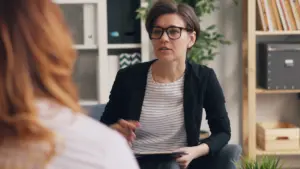Two adults in a thoughtful therapy conversation about choosing the right level of DBT support.