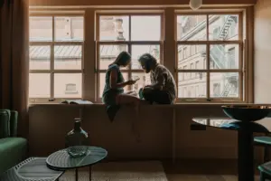 Two adults having a thoughtful conversation at home about connection, rejection and relationship patterns.