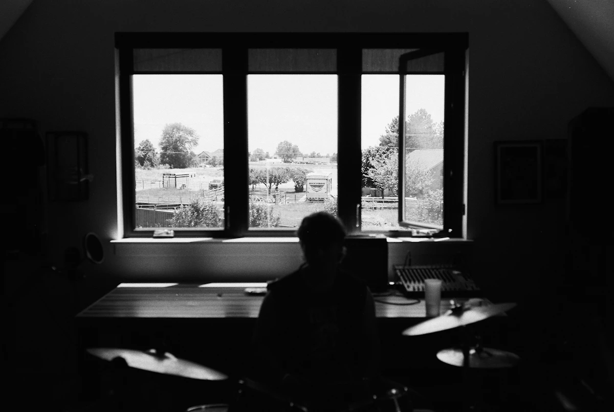 Adult sitting quietly by a window in a reflective moment after previous therapy experiences.